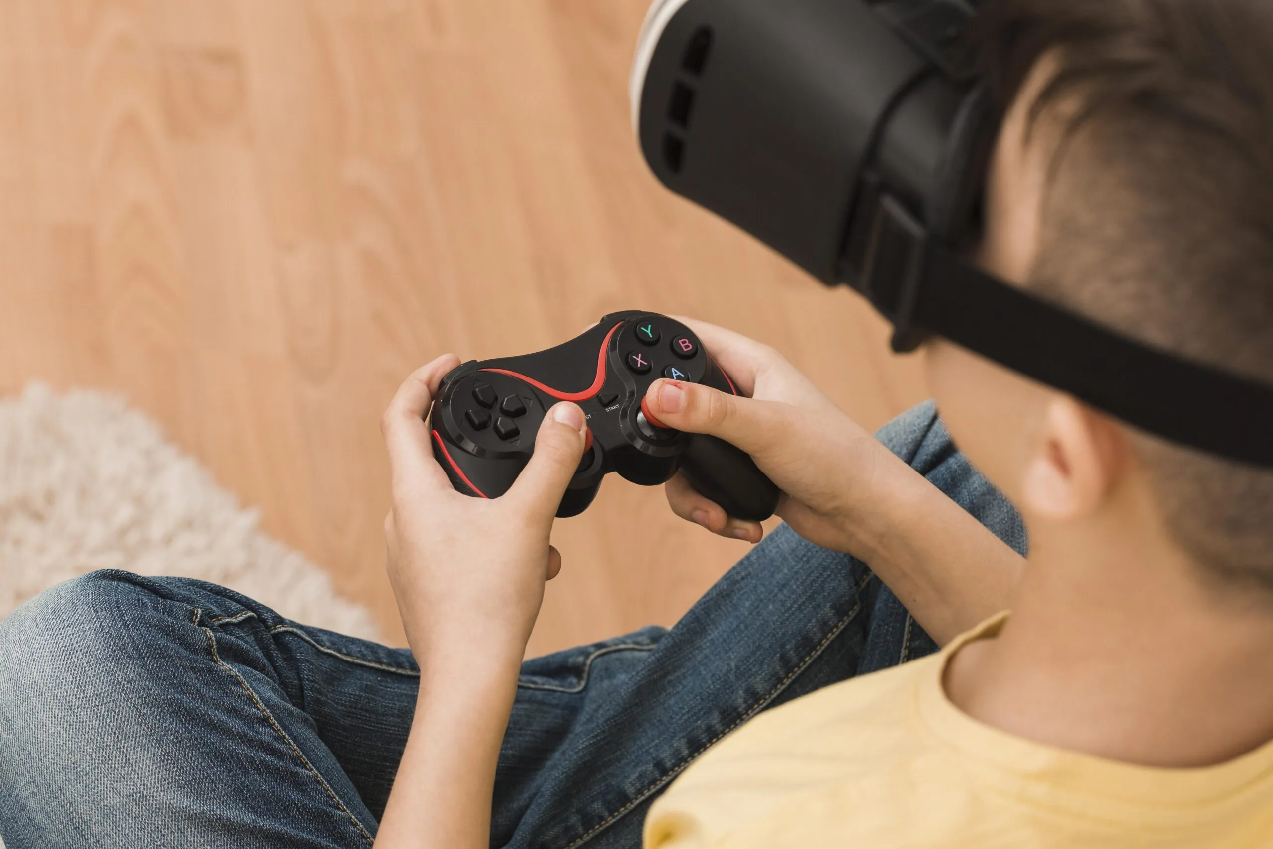 A boy playing a video game using VR goggles 